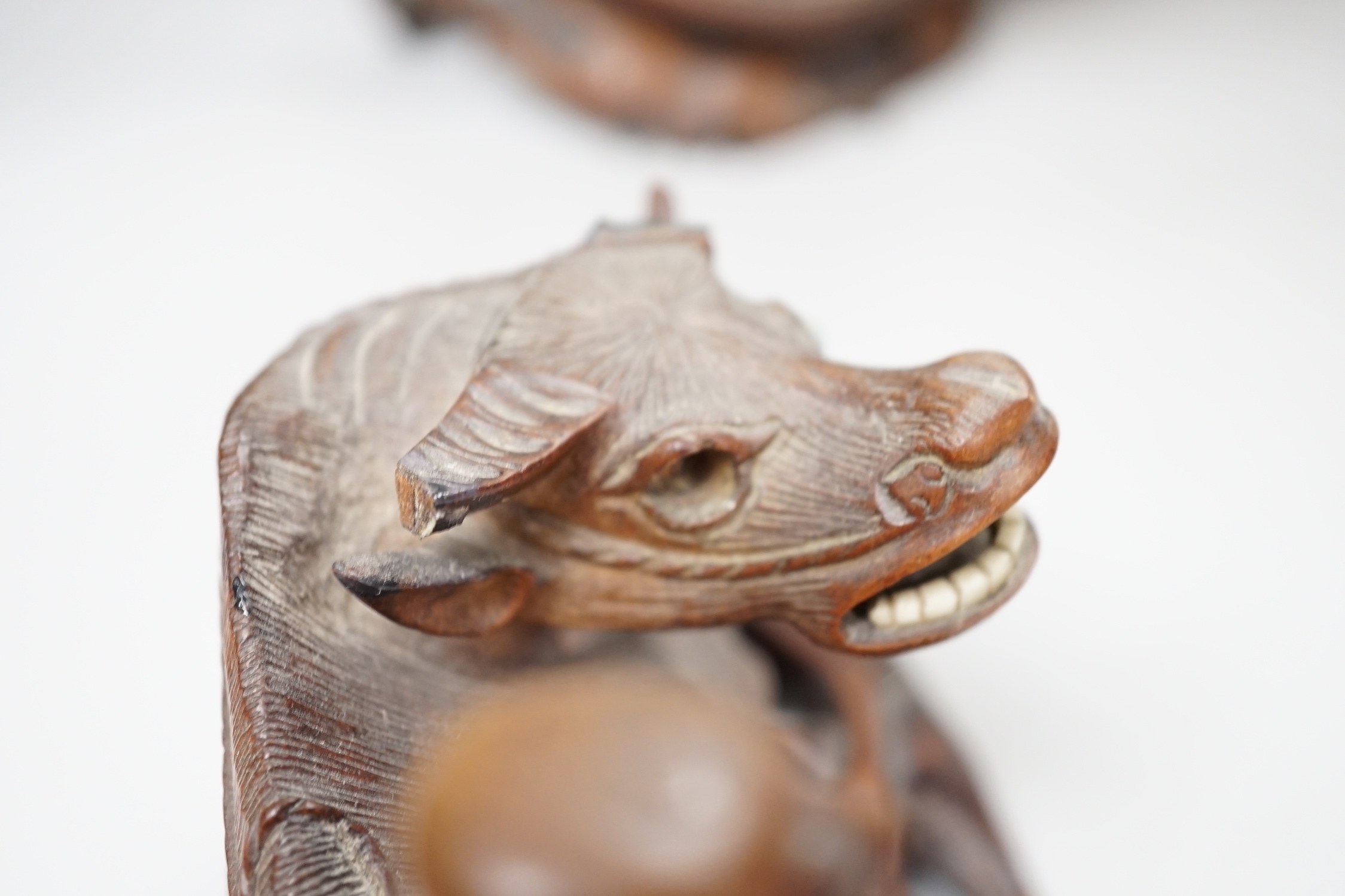 A pair of Chinese carved hardwood buffalo carvings, and a similar figure of a luohan, latter 24cm - damaged
